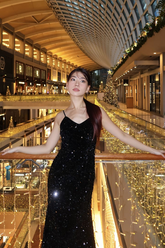a lady in a black sequin velvet dress